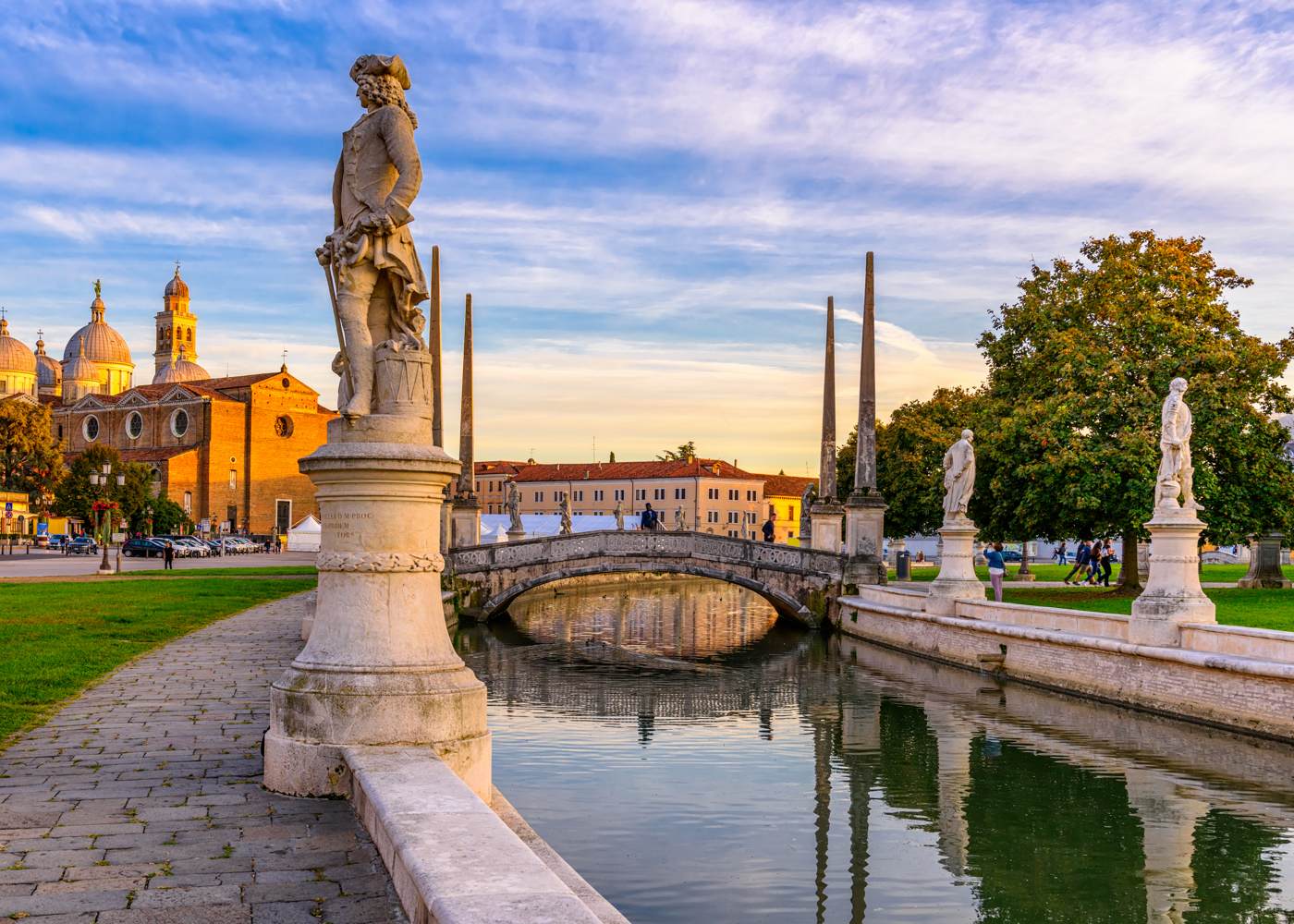 Canal with statues on square Prato della Valle and Basilica Santa Giustina